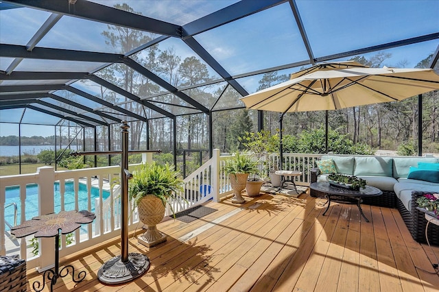 sunroom featuring plenty of natural light, vaulted ceiling, and a water view