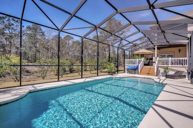 view of pool featuring a patio, a lanai, and a wooden deck