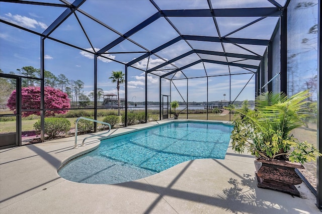 view of pool with a patio area and a lanai