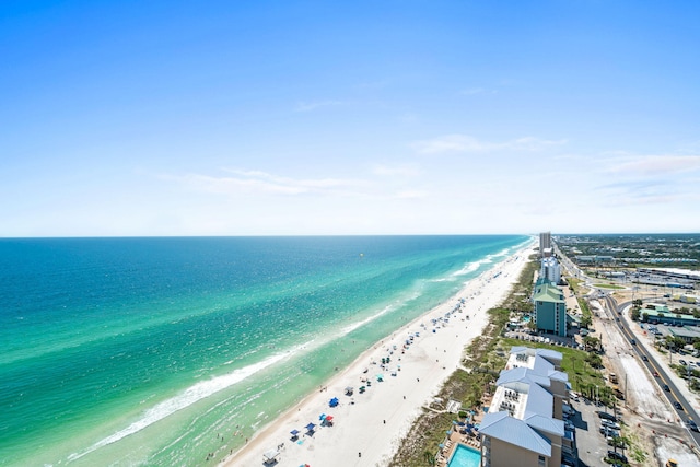 drone / aerial view featuring a water view and a beach view