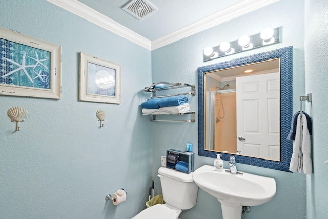 bathroom with toilet, walk in shower, ornamental molding, and sink