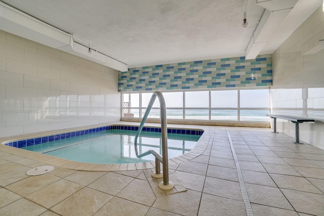 view of pool featuring a water view