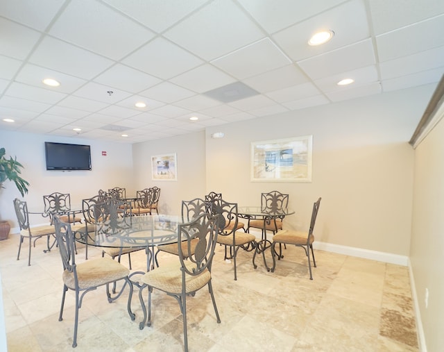 dining area with a drop ceiling