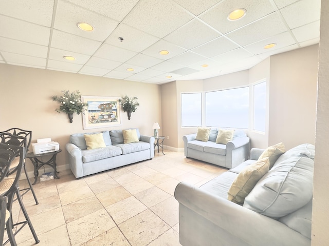 living room featuring a paneled ceiling