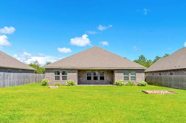 rear view of house featuring a lawn