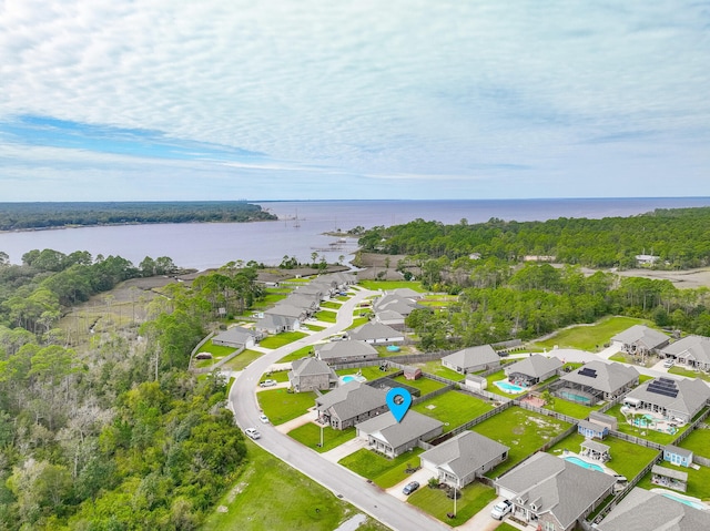 birds eye view of property with a water view and a residential view