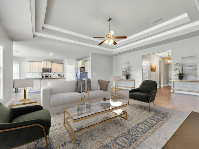 3527 Turquoise Dr, Navarre, FL 32566 - living room featuring a ceiling fan, visible vents, and a raised ceiling