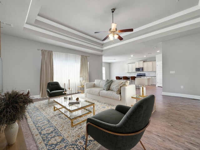 3527 Turquoise Dr, Navarre, FL 32566 - living area with ceiling fan, wood finished floors, baseboards, a tray ceiling, and recessed lighting
