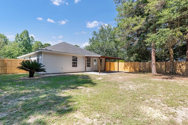 rear view of property featuring a patio area and a lawn