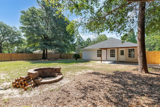 view of yard featuring a patio and a fire pit