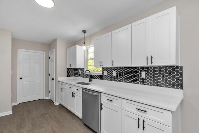 kitchen with stainless steel dishwasher, white cabinetry, and hanging light fixtures