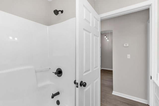 bathroom featuring hardwood / wood-style floors and shower / bathtub combination