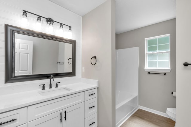 full bathroom with hardwood / wood-style flooring, vanity, toilet, and bathing tub / shower combination