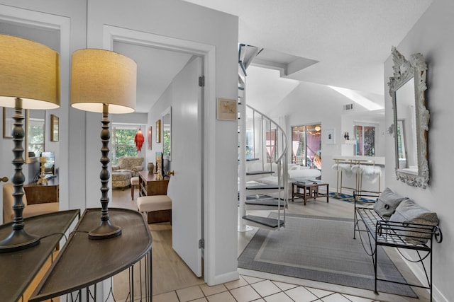 dining space featuring light tile patterned floors and vaulted ceiling