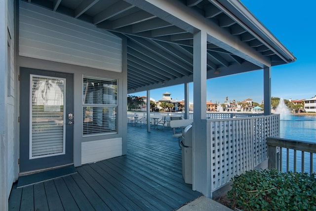 wooden terrace featuring a water view