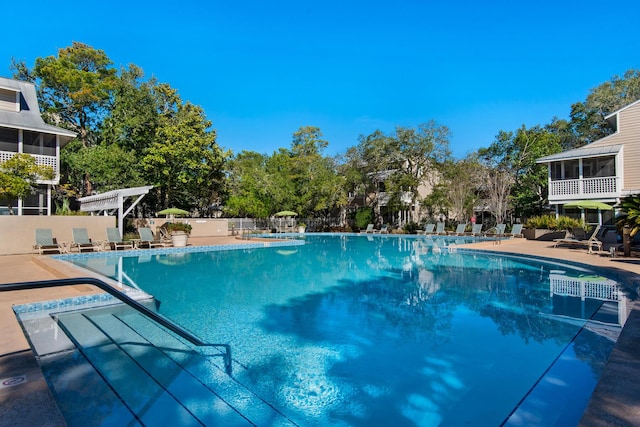 view of swimming pool with a patio and a pergola