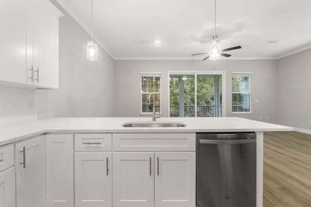 kitchen featuring decorative light fixtures, sink, white cabinets, ornamental molding, and stainless steel dishwasher