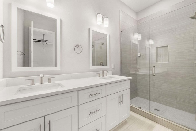 bathroom featuring walk in shower, ceiling fan, and vanity