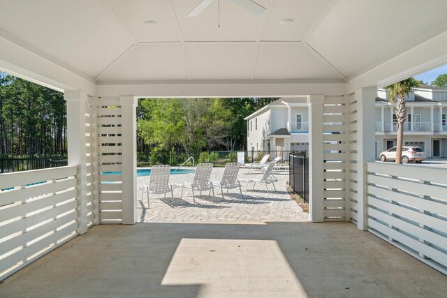 view of patio with a gazebo, a community pool, and ceiling fan