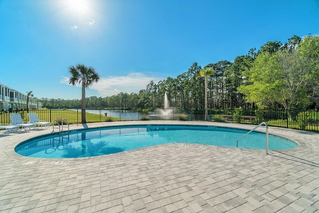 view of pool with a water view and a patio