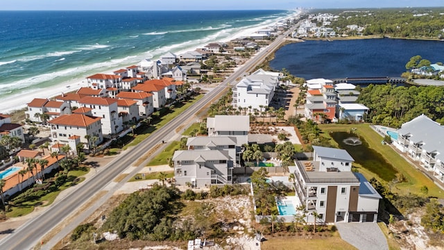 drone / aerial view with a water view and a beach view