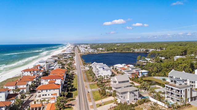 drone / aerial view with a water view and a beach view