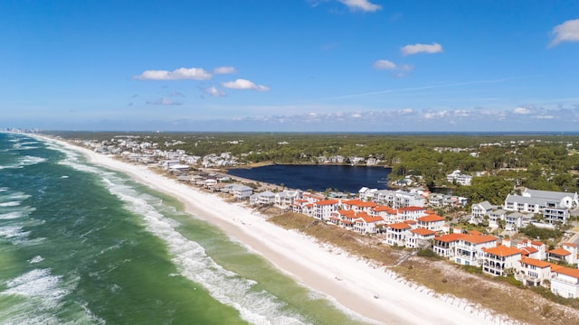 birds eye view of property with a beach view and a water view