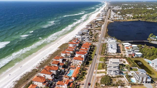 birds eye view of property with a water view and a view of the beach