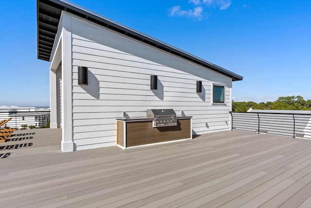 deck featuring area for grilling and exterior kitchen