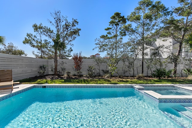 view of pool with an in ground hot tub