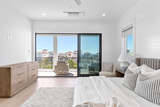 bedroom featuring access to exterior and light hardwood / wood-style flooring