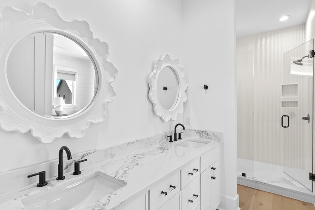 5050 W County Highway 30a, Santa Rosa Beach, FL 32459 - bathroom featuring double vanity, a stall shower, and a sink