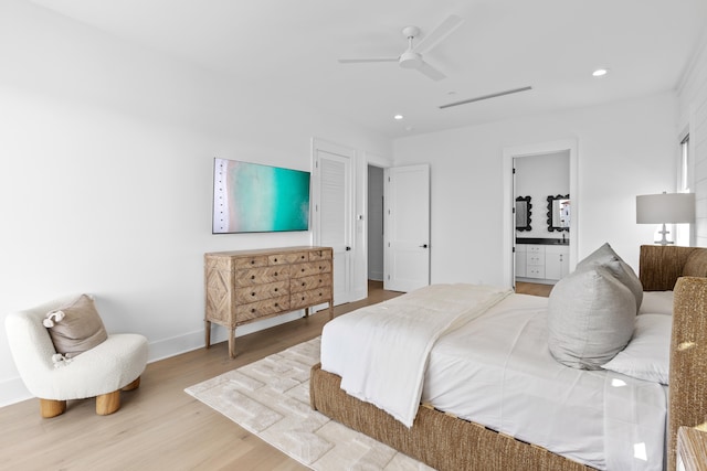 bedroom with connected bathroom, ceiling fan, and wood-type flooring