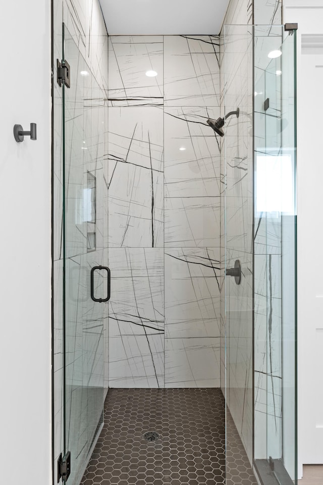 bathroom with a shower with shower door