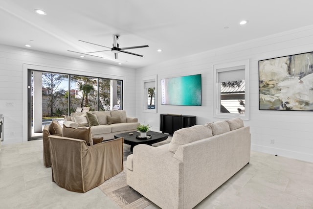 living room featuring ceiling fan and wooden walls