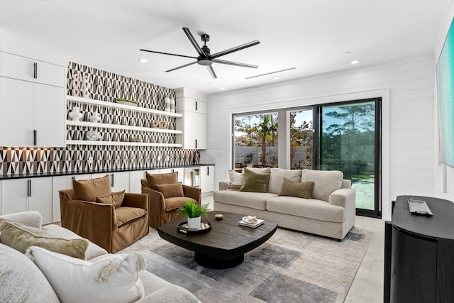 living room with wooden walls and ceiling fan