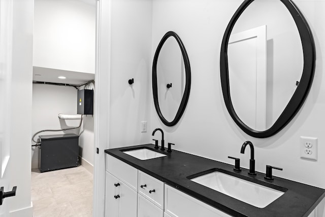 5050 W County Highway 30a, Santa Rosa Beach, FL 32459 - bathroom featuring double vanity, baseboards, and a sink