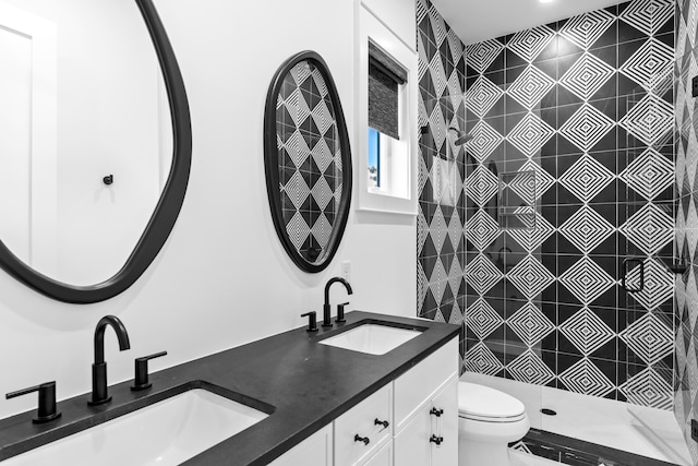 bathroom featuring vanity, toilet, and walk in shower