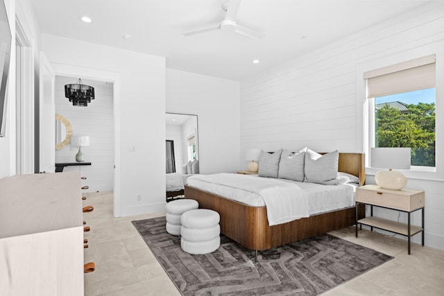 bedroom featuring ceiling fan with notable chandelier