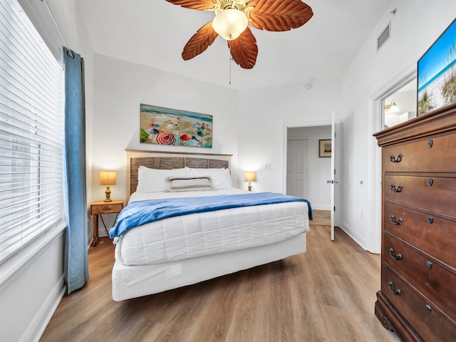 bedroom with ceiling fan and light hardwood / wood-style floors