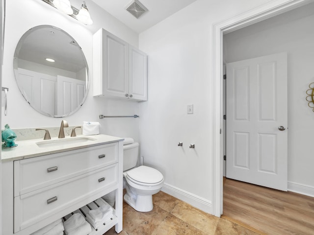 bathroom with vanity, hardwood / wood-style floors, and toilet