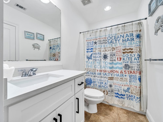 bathroom with vanity, walk in shower, tile patterned floors, and toilet