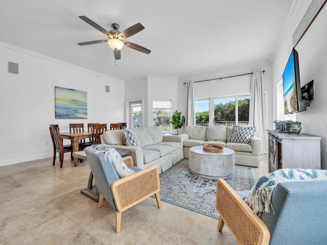 living room with ornamental molding and ceiling fan