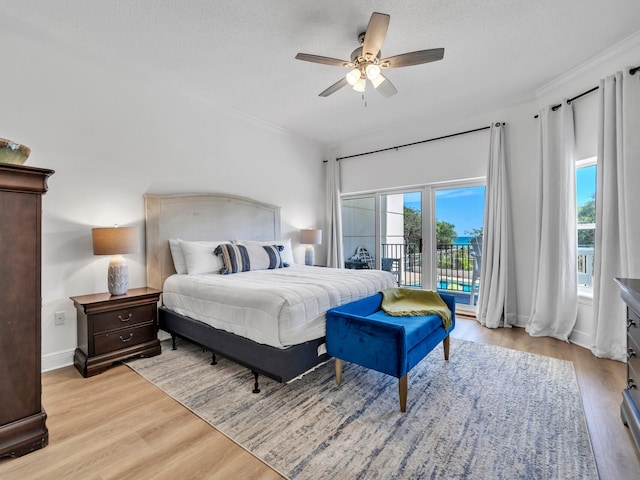 bedroom with a textured ceiling, access to outside, ornamental molding, ceiling fan, and light hardwood / wood-style floors