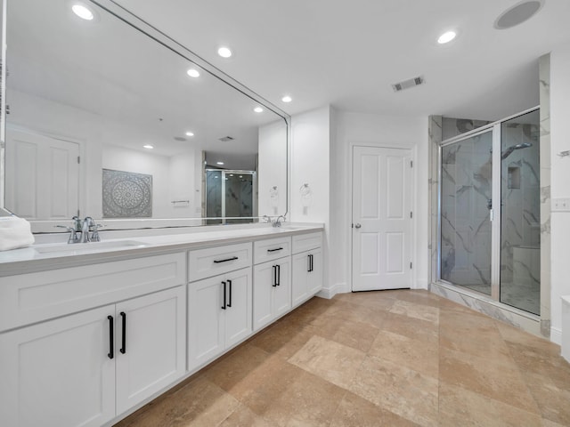 bathroom featuring walk in shower and vanity