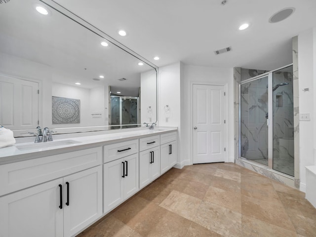 bathroom featuring vanity and a shower with door