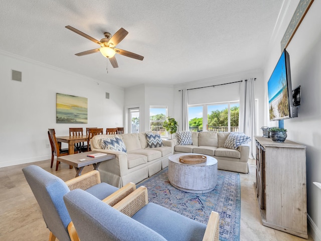 living room featuring ceiling fan and a textured ceiling