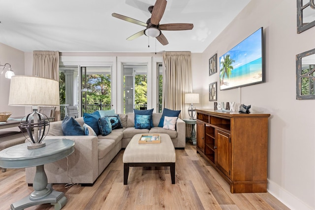 living room with ceiling fan and light hardwood / wood-style flooring