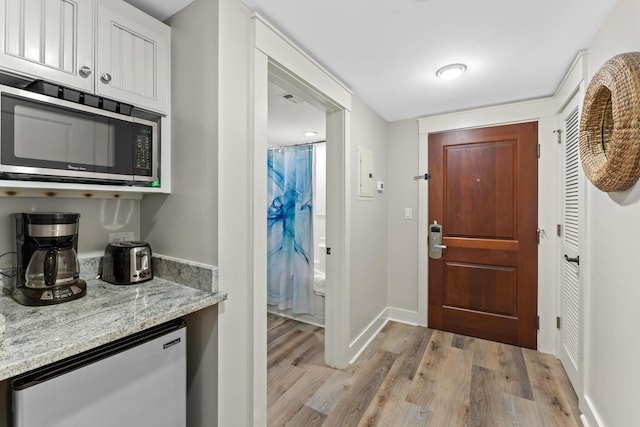 foyer entrance with light hardwood / wood-style flooring