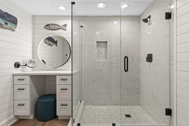 bathroom with vanity, wood-type flooring, and an enclosed shower